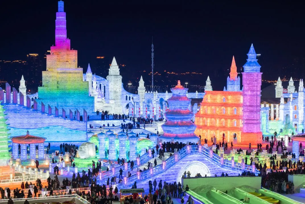 Giant ice castle lit up at night