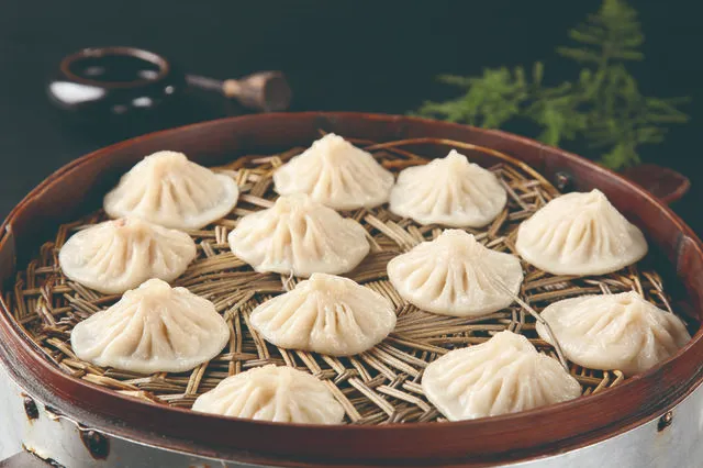 Delicate soup dumplings in a steamer basket
